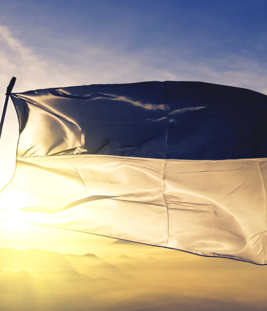 Fribourg canton of Switzerland flag textile cloth fabric waving on the top sunrise mist fog