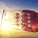 Valais canton of Switzerland flag textile cloth fabric waving on the top sunrise mist fog